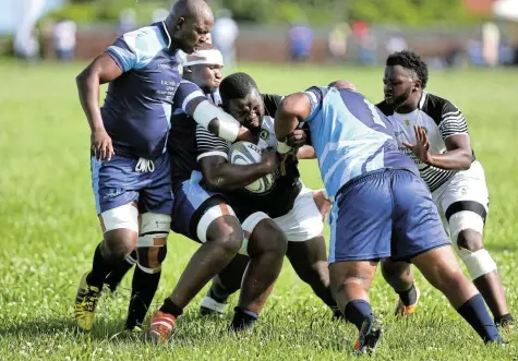  ?? Picture: MARK ANDREWS ?? HEAVY BRIGADE: Old Boys’ tighthead prop Masimdumis­e Nkomo runs into the Swallows’ defence during the Super 14 club clash in Mdantsane on Saturday