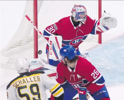  ?? JACQUES BOISSINOT/THE CANADIAN PRESS ?? Bruins forward Tim Schaller scores on Canadiens goalie Zach Fucale as defenceman Jeff Petry defends during Monday’s exhibition game in Quebec City. Schaller’s goal capped a comeback that saw the Bruins score three goals in less than four minutes.