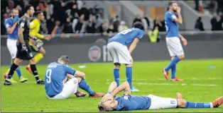  ?? ASSOCIATED PRESS PHOTO/LUCA BRUNO ?? Italy’s Ciro Immobile (foreground) and Italy’s Andrea Belotti (seated left) react to their team’s eliminatio­n in the World Cup qualifying playoff second leg soccer againstd Sweden at the Milan San Siro stadium on Monday.