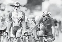  ?? CHRISTOPHE ENA THE ASSOCIATED PRESS ?? France’s Arnaud Demare, left, celebrates as he crosses the finish line to win the 18th stage of the Tour de France cycling race over 171 km.