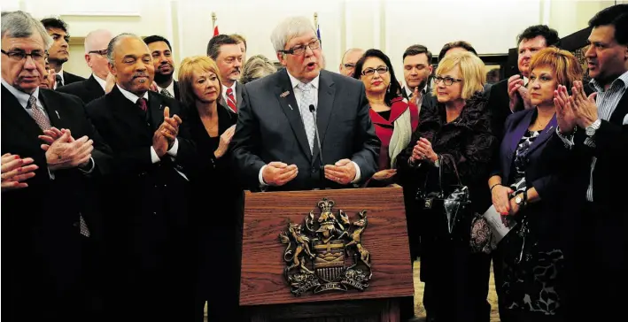  ?? BRUCE EDWARDS/EDMONTON JOURNAL ?? Dave Hancock is welcomed by MLAs and cabinet ministers after being sworn in as Alberta’s 15th premier at Government House on Sunday night.