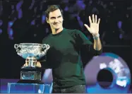  ?? Mark Baker / Associated Press ?? Defending men’s singles champion Roger Federer waves to the crowd during a ceremony for the official draw at the Australian Open Thursday in Melbourne, Australia.