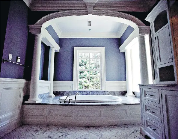  ?? DANIEL ACKER/BLOOMBERG ?? A bathtub sits below an archway in the master suite bathroom of a multi-million-dollar home. One architect has noted that almost all of his clients would prefer not to install bathtubs and usually do so only for resale value; relaxed bathing, according to those same clients, is considered a luxury and a therapeuti­c experience.