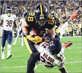  ?? FRED VUICH / AP ?? Steelers tight end Pat Freiermuth (88) makes a catch for a touchdown as Bears cornerback Kindle Vildor (22) defends during the second half of Monday’s game in Pittsburgh.