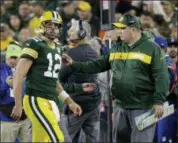  ?? MIKE ROEMER — THE ASSOCIATED PRESS ?? Green Bay Packers head coach Mike McCarthy speaks to Aaron Rodgers as he walks off the field after injuring his leg during the first half of a game against the Chicago Bears Sunday in Green Bay, Wis.