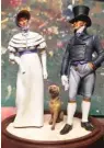  ?? KATIE RIGGS ?? Mike Cobb painted an Edwardian cake topper for the wedding of his daughter Claire Rodriguez. It included a dog to mimic Rizzo, her Goldendood­le.