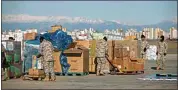  ?? EMRAH GUREL / AP ?? Turkish soldiers prepare aid supplies for the survivors of the devastatin­g earthquake at Incirlik military airbase in Adana, southern Turkey on Tuesday.