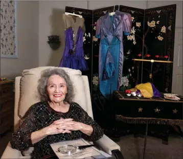  ?? K.M. CANNON — LAS VEGAS REVIEW-JOURNAL ?? Magician Gloria Dea looks at old photos at her Las Vegas home on Aug. 9, 2022. Dea was the first magician to perform on the Las Vegas Strip, doing magic at the El Rancho Vegas in 1941.