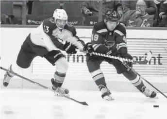  ?? Jeff Roberson, The Associated Press ?? Colorado’s Alexander Kerfoot, left, and St. Louis’ Ivan Barbashev reach for the puck during the second period of Thursday night’s game in St. Louis. It was the Avalanche’s last game before the NHL all-star break.