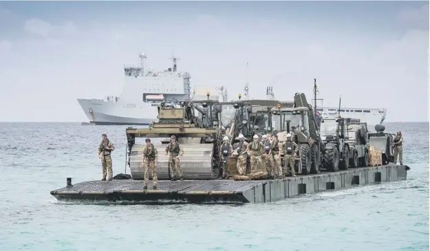  ?? PICTURE: PA ?? 0 A landing raft from RFA Mounts Bay heads for shore in the Turks and Caicos islands with equipment for use in the rebuild after Hurricane Irma