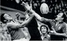  ??  ?? John Kirwan, centre, contests a high ball during the 1986 series against France where the so-called Baby Blacks pulled off a shock victory.