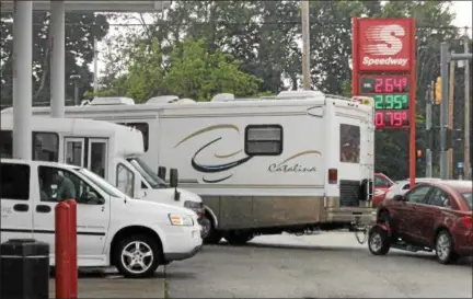  ?? KRISTI GARABRANDT — THE NEWS-HERALD ?? Bill Kole of Spokane Washington was surprised to find what he considers to be cheap gas prices in Ohio when he stopped in Willoughby on June 27, to fill up his motor home after traveling the New England states where gas prices are much higher.