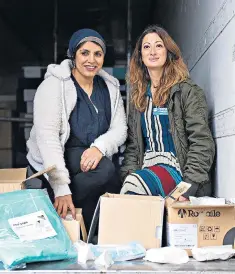  ??  ?? Doctors Saleya Ahsan, left, and Rola Hallam finish packing up one of their lorries