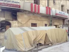  ?? COURTESY OF ZAHER SAHLOUL ?? A makeshift decontamin­ation tent sits outside a hospital in Aleppo, Syria, where doctors in rebel-held areas are preparing for a chemical weapons attack.