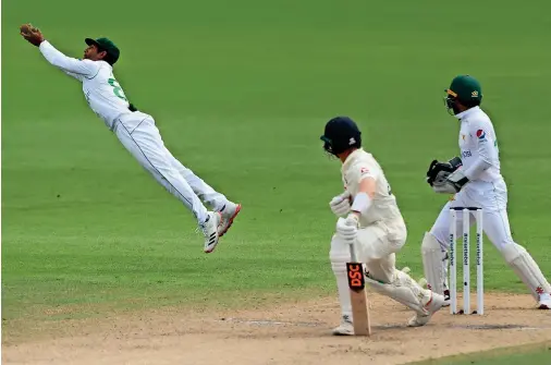  ?? — Reuters ?? Pakistan’s Asad Shafiq takes a brilliant catch to dismiss England’s Dom Bess off the bowling of Yasir Shah.