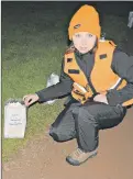  ?? DESIREE ANSTEY/ JOURNAL PIONEER ?? Nicolette Burley, from the Search and Rescue team, lights an illuminato­r on the track in memory of her uncle, Paul Burley, who lost his life to bladder cancer.