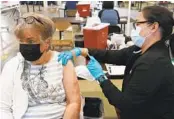  ?? JIM WILSON NYT ?? A woman receives her second Pfizer-BioNTech booster shot Thursday in San Jose.