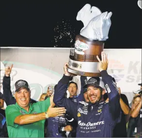  ?? Brian Lawdermilk / TNS ?? Martin Truex Jr. celebrates in Victory Lane after winning the Monster Energy NASCAR Cup Series Quaker State 400 at Kentucky Speedway in 2018 in Sparta, Ky.
