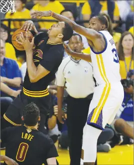  ?? AP PHOTO ?? Kevin Durant (right) defends against Cleveland’s Channing Frye during Game 2 of the NBA Finals on Sunday.