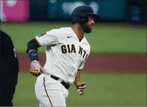  ??  ?? The San Francisco Giants’ Brandon Belt heads to home plate after hitting a three-run home run against the Los Angeles Dodgers in the first inning at Oracle Park in San Francisco on Aug. 25, 2020.