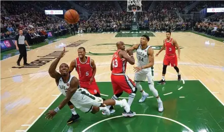  ??  ?? Eric Bledsoe (left) of Milwaukee Bucks goes for a shoot during their NBA game against the Portland Trail Blazers in Milwaukee on Thursday. The Bucks won 137-129. — AP