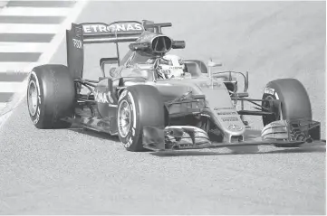  ??  ?? Mercedes Formula One driver Lewis Hamilton of Britain takes a curve with his car during the fourth testing session ahead the upcoming season at the Circuit Barcelona-Catalunya in Montmelo, Spain, in this Feb 25 file picture. — Reuters photo