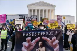  ?? ANDREW HARNIK — THE ASSOCIATED PRESS ?? Stephen Parlato of Boulder, Colo., holds a sign as abortion rights advocates and antiaborti­on protesters demonstrat­e in front of the U.S. Supreme Court in Washington on Wednesday.