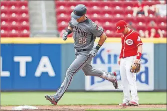  ?? [JOHN MINCHILLO/THE ASSOCIATED PRESS] ?? Jake Lamb circles the bases after hitting a three-run homer off Reds starter Luis Castillo in the first inning, giving the Diamondbac­ks a 3-0 lead before they had made their first out.