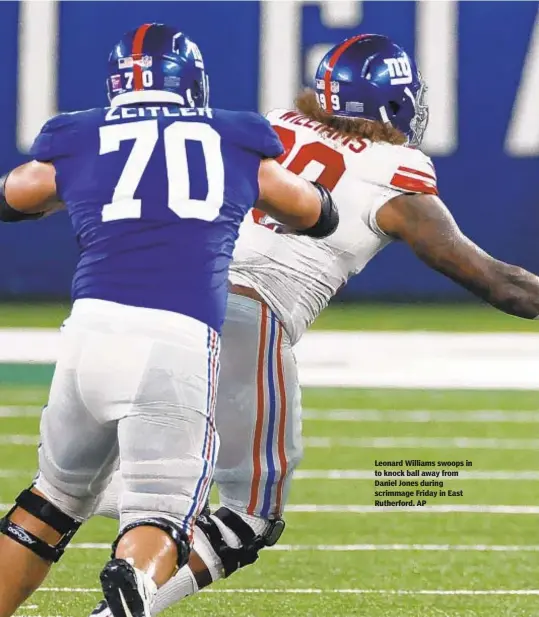  ??  ?? Leonard Williams swoops in to knock ball away from Daniel Jones during scrimmage Friday in East Rutherford. AP