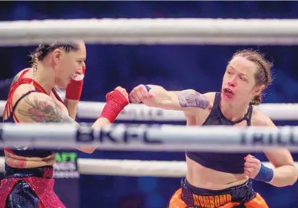  ?? CHANCEY BUSH/ASSOCIATED PRESS ?? Jayme Hinshaw, right, throws a punch at Charisa Sigala during their bout Friday night at the Knuckle-Mania 3 Bare Knuckle Fight Championsh­ip at Tingley Coliseum.