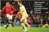  ?? — AP ?? Manchester United’s Cristiano Ronaldo scores against Arsenal.
