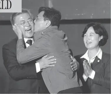  ?? AHN YOUNG-JOON / THE ASSOCIATED PRESS ?? South Chungcheon­g governor Ahn Hee-jung kissed South Korean presidenti­al candidate Moon Jae-in of the Democratic Party as he arrived to give his winner’s speech in Seoul, South Korea, Tuesday. Moon declared victory in the presidenti­al election after...