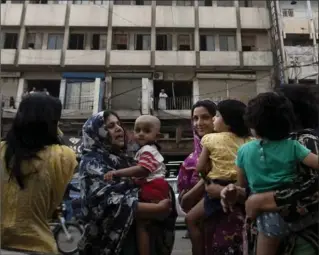  ?? SHAKIL ADIL, THE ASSOCIATED PRESS ?? People evacuate buildings and gather on the street as Tuesday’s earthquake was felt in Karachi, Pakistan.