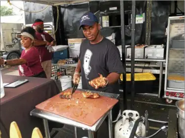  ?? ANDREW CASS — THE NEWS-HERALD ?? Off the Bone BBQ of Mobile, Alabama travels to rib events all across the country. The restaurant returned to Dudley Park this year after winning “Best Ribs” at the inaugural Willowick Rib Burn Off in 2017.