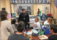  ?? JEREMY P. KELLEY / STAFF ?? Kettering police School Resource Officer Edward Drayton talks to Fairmont High School students about their day during at lunch Thursday. Drayton says daily relationsh­ipbuilding makes it easier for students and staff to come to him with safety concerns.