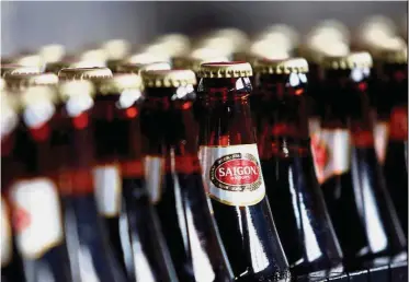  ??  ?? Vietnam beer: A file picture showing bottles of beer moving along a production line at a Sabeco factory in Hanoi. ThaiBev’s local unit Vietnam Beverage won the bidding for a 54% stake in Sabeco. — Reuters