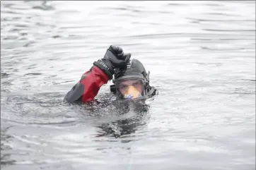  ?? @TMartinHer­ald Herald photo by Tijana Martin ?? Mitch Dirk of the Lethbridge Fire Department signals his partner during a dive training exercise at RiverStone Lake in William Pearce Park on Tuesday.