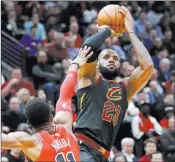  ?? Charles Rex Arbogast ?? The Associated Press Cavaliers forward Lebron James lines up a shot over Bulls guard David Nwaba in the first half of Cleveland’s 113-91 win Monday at the United Center.