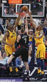  ?? AP ?? Ekpe Udoh ( left) and Derrick Favors ( right) of Utah Jazz block a basket by Sam Dekker of Los Angeles Clippers in their NBA game in Salt Lake City on Thursday. The Jazz won 117- 95. —