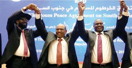  ??  ?? South Sudan President Salva Kiir (left), Sudan’s President Omar Al-Bashir (middle) and South Sudan rebel leader Riek Machar hold hands after signing a peace agreement aimed to end a war in which tens of thousands of people have been killed, in Khartoum.