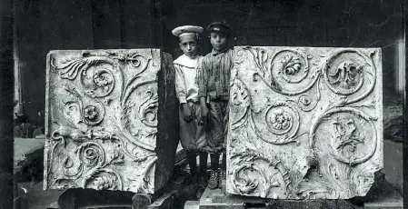  ??  ?? In posa Bambini tra due frammenti dell’Ara Pacis: è una delle immagini che compongono «Alfabeto fotografic­o romano»