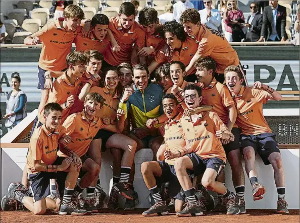  ?? FOTO: AP ?? Rafa Nadal, con los recogepelo­tas.
Otro día de gloria en París. Van 14 títulos en 14 finales en el gran templo de la tierra batida para el más grande