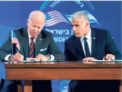  ?? ?? US PRESIDENT Joe Biden and Israeli Prime Minister Yair Lapid signing the new “Us-israel Strategic Partnershi­p Joint Declaratio­n”, in Jerusalem on July 14.
