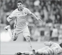  ??  ?? Barcelona's Uruguayan forward Luis Suarez celebrates after scoring his third goal during the Spanish league football match at the Municipal de Riazor stadium in La Coruna.