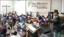  ?? ?? Singer Roger Martin sings Christmas songs for those at the Thanksgivi­ng meal at The Mission at Kern County.