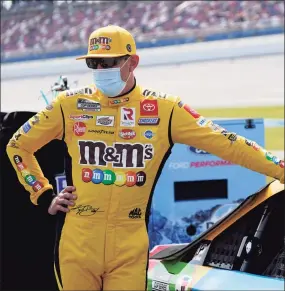  ?? John Bazemore / Associated Press ?? Kyle Busch waits next to his car before the YellaWood 500 at Talladega Superspeed­way on Oct. 5 in Talladega, Ala.