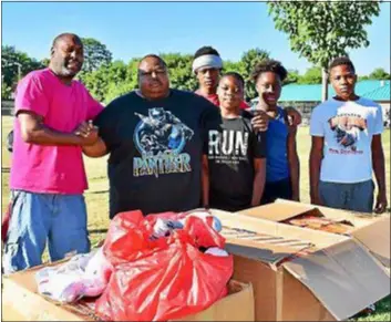  ??  ?? Unifying Group of Media founder/president Eric Townes and Chester Panthers coach Charles Thompson and some players pose for a photo after Townes brought a donation of hundreds of pairs of cleats to the Panthers. The Unifying Group of Media is a group of volunteers who help to instill good values in youth by keeping them involved in positive activities and helping them gain the feeling of being a vital part of the community at-large.