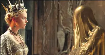  ??  ?? The Queen (Charlize Theron, left) consults with the Mirror Man in the epic action-adventure “Snow White and the Huntsman,” the new vision of the legendary tale from the producer of “Alice in Wonderland.”