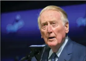  ?? MARK J. TERRILL - THE ASSOCIATED PRESS ?? Hall of Fame broadcaste­r Vin Scully speaks to reporters about being inducted into the Los Angeles Dodgers Ring of Honor, prior to a baseball game between the Dodgers and the San Francisco Giants, Wednesday in Los Angeles.