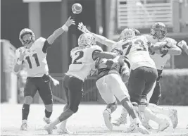  ?? GERRY BROOME/AP ?? UCF quarterbac­k Dillon Gabriel throws against East Carolina on Saturday in Greenville, N.C. The sophomore completed 32 passes for 408 yards and four TDs in a 51-28 victory.